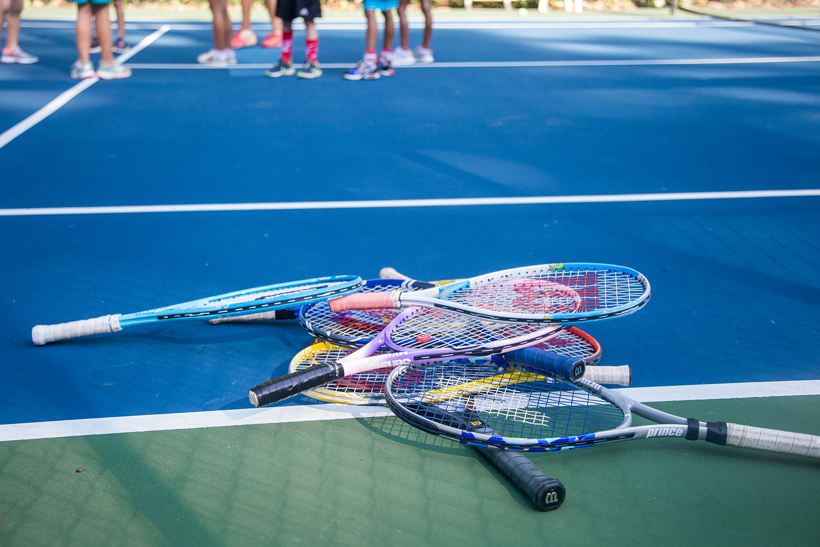 Photo of a stack of four tennis rackets at Rock Creek Tennis Center